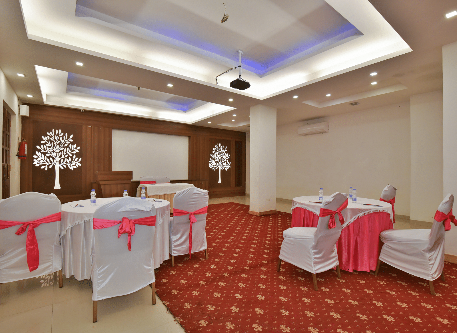 A conference hall with comfortable chairs facing the podium at DLS Highland Resort and Spa, Mussoorie.